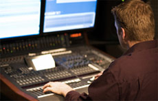 Post Production Management - graphic of person at a master control table 